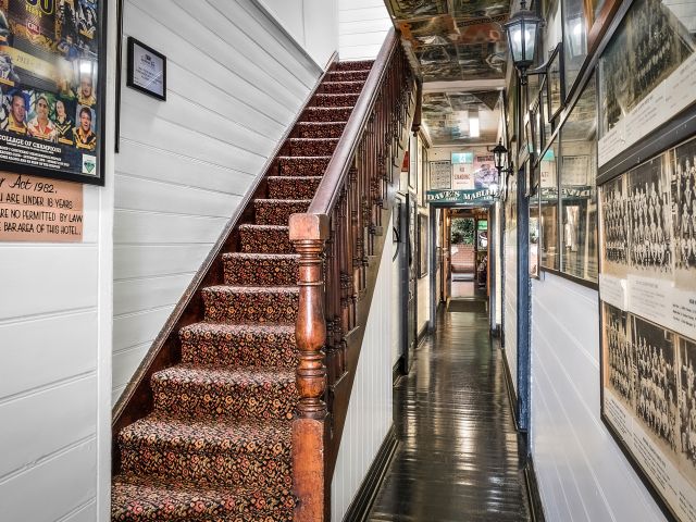a rustic staircase inside The Historic Jamberoo Pub