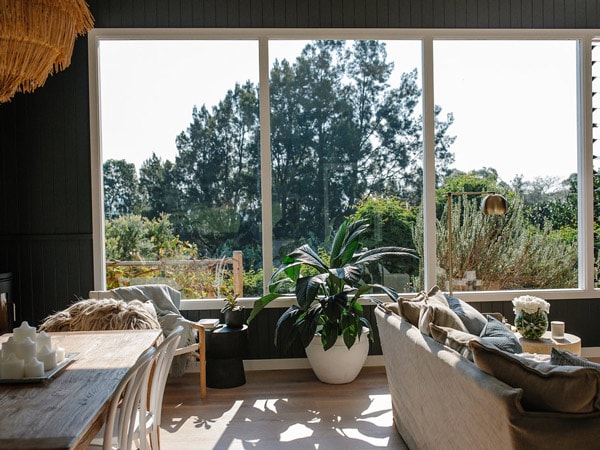 the cottage interior with huge windows at Jamberoo Valley Farm Cottage