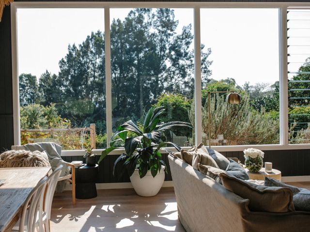 the cottage interior with huge windows at Jamberoo Valley Farm Cottage