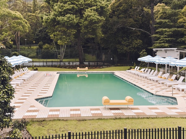 an outdoor pool with sunloungers at The Lodge Jamberoo