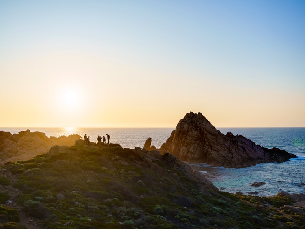 hikers on the Cape to Cape Walk admiring the Sugarloaf Rock