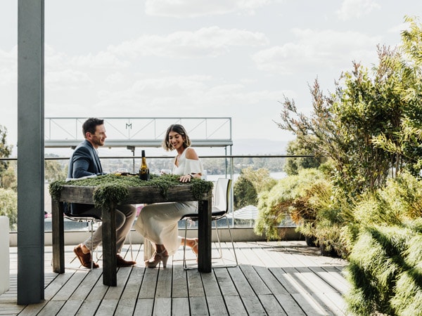 a couple dining al fresco at The Source
