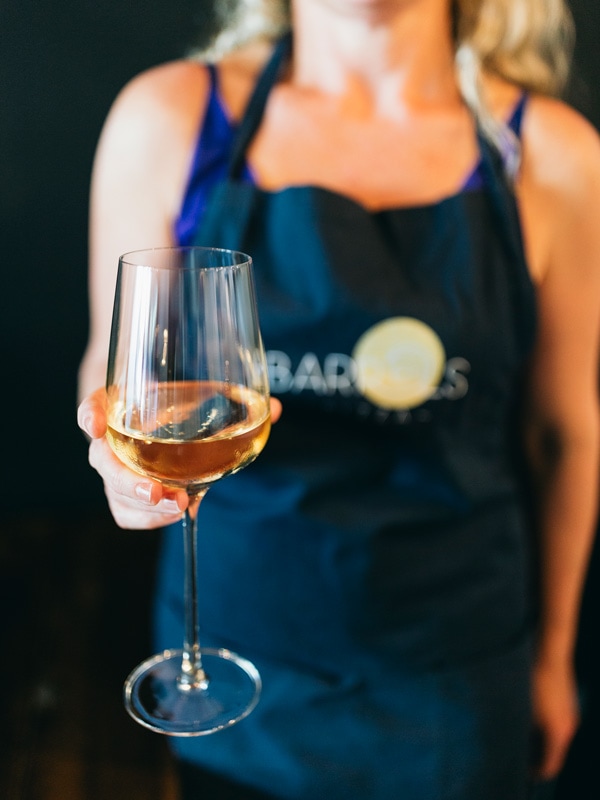 a woman holding a wine glass at Barrels Pizza Restaurant