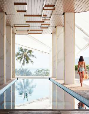 a woman walking by the pool at Crystalbrook Flynn, best accommodation in Cairns