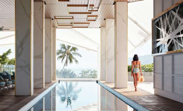 a woman walking by the pool at Crystalbrook Flynn, best accommodation in Cairns