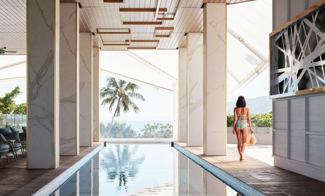 a woman walking by the pool at Crystalbrook Flynn, best accommodation in Cairns