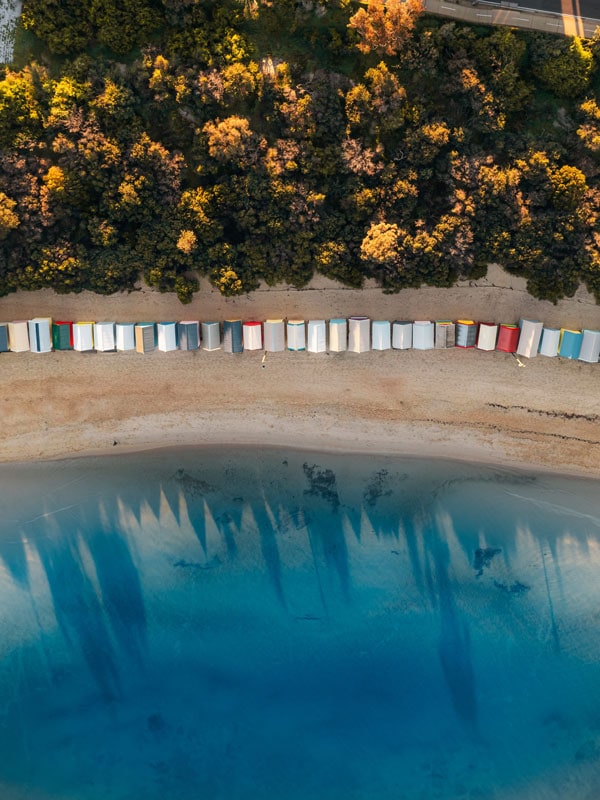 an aerial shot of colourful, Victorian bathing boxes at Brighton Beach, Vic
