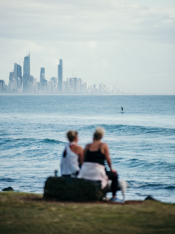 two people sitting on Burleigh Hill watching the surfers, instagrammable place in Australia