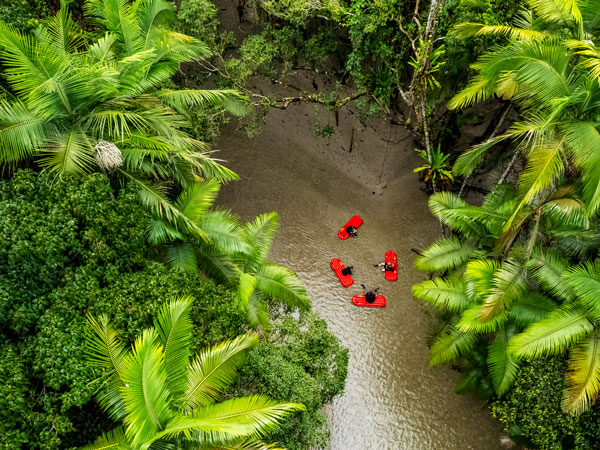 a group of people in river sleds in Mossman Gorge rainforest on the River Drift Experience tour, Back Country Bliss