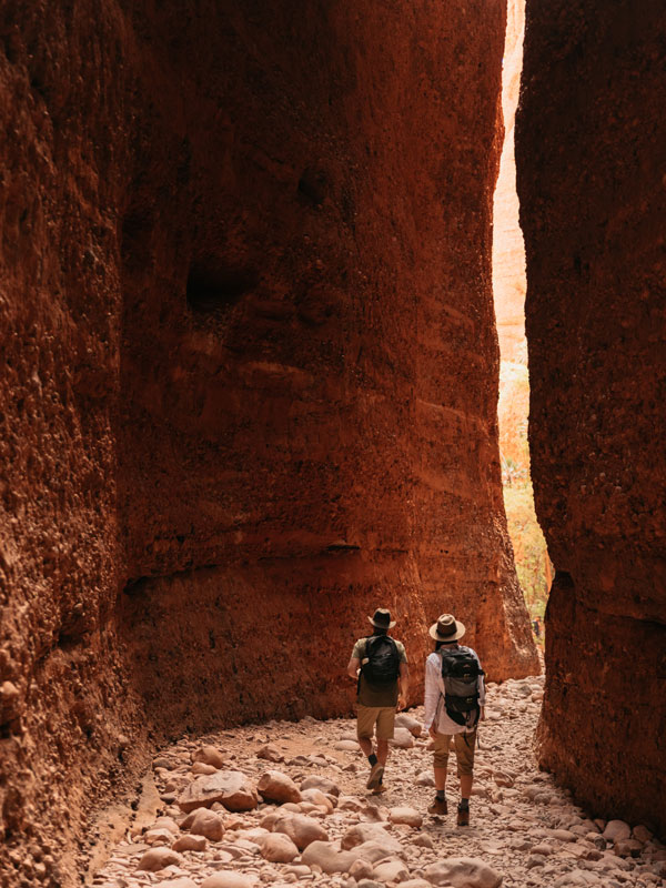 two hikers entering the narrow gorge at Echidna Chasm, Purnululu National Park