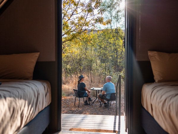 a couple outside a tent at El Questro