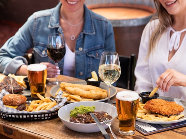 two people enjoying food and drinks at Family Hotel, Bathurst