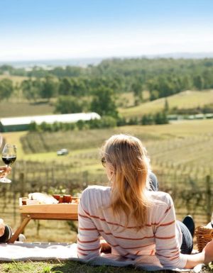 a couple enjoying a romantic date among the vines in the Hunter Valley
