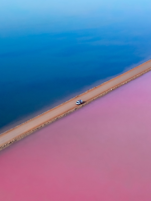 an aerial view of a car driving along Lake MacDonnell in South Australia