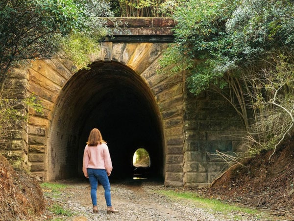a woman standing at Mushroom Tunnel, Picton, NSW
