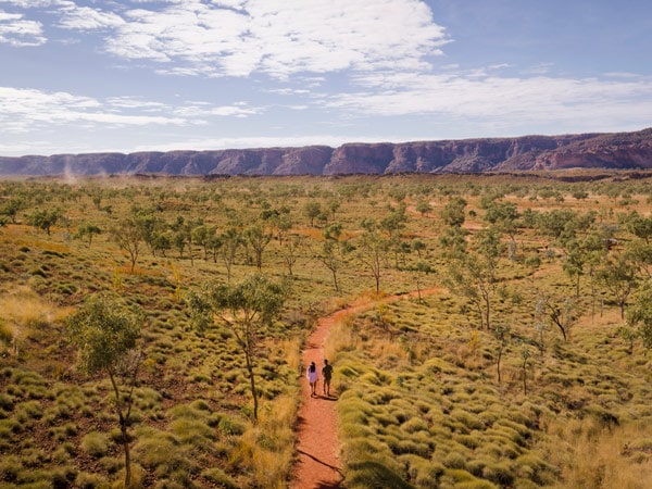 an aerial view of two people walking at Purnululu National Park