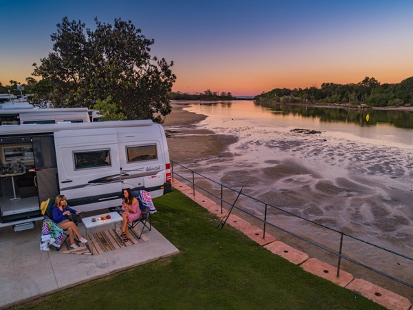 a top view of two people sitting outside a caravan at low tide, Tweed Holiday Parks, Kingscliff Beach 