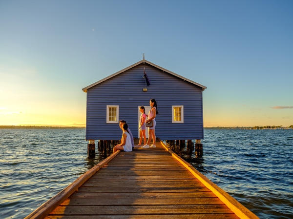 a family relaxing in front of The Crawley Edge Boatshed in Perth, WA
