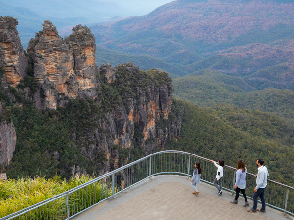 Family enjoying views across Blue Mountains National Park to the Three Sisters and Mount Solitary from Echo Point Lookout