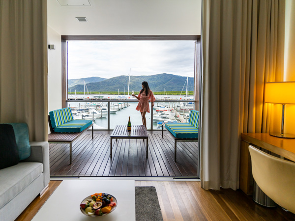a woman relaxing on the balcony with a glass in hand, Shangri-La The Marina, best accommodation in Cairns