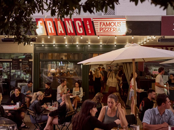 people dining outside Franc Jrs, Coolangatta