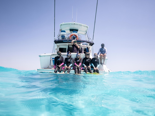 a group of tourists posing for a photo op during their Live Ningaloo tour