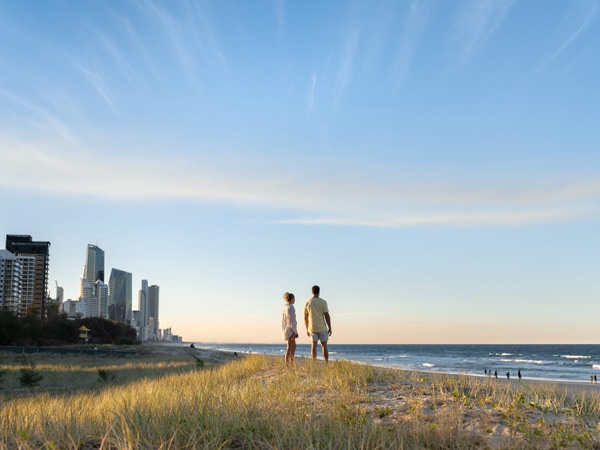 couple looking out at ocean on the dunes at Broadbeach