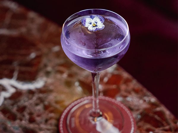 a glass of purple cocktail at Cardea, Sydney NSW