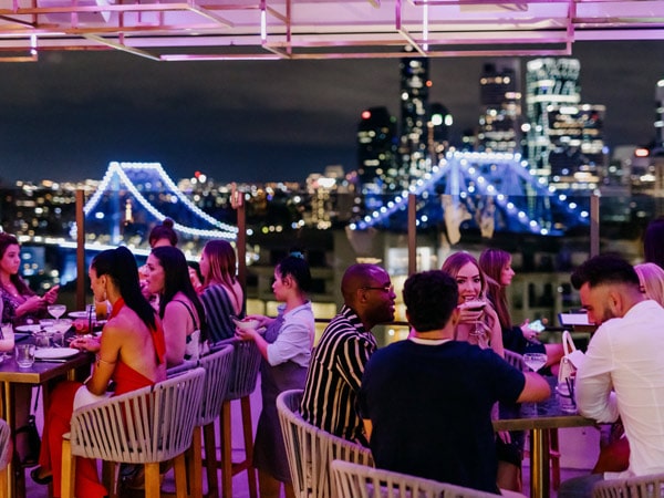 dining at night with the shimmering city lights in the background at Iris at Hotel X, Brisbane, Qld