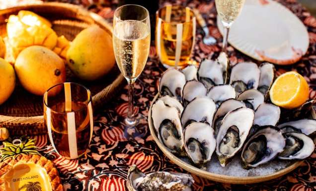 A spread of mangoes, oysters and champagne