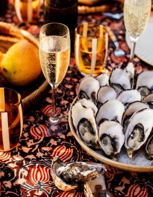A spread of mangoes, oysters and champagne