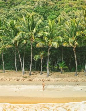 Woman coming out of the water at Ellis Beach in Cairns