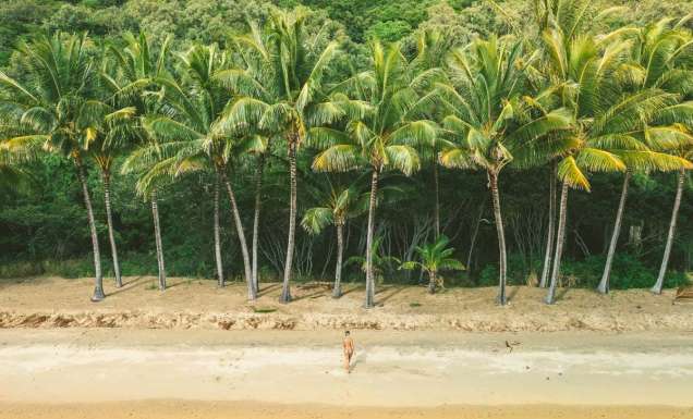 Woman coming out of the water at Ellis Beach in Cairns
