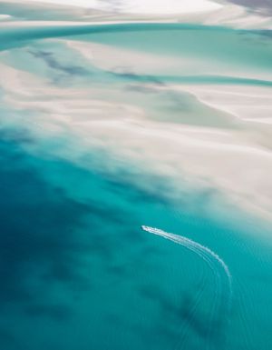 Aerial view of a boat cruising through the Whitsundays