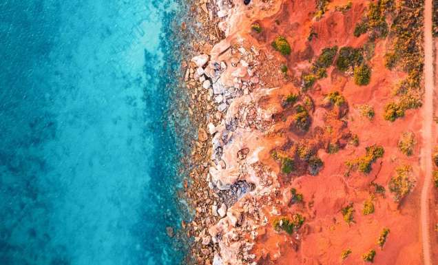 an aerial view of the sandstone cliffs of Gantheaume Point, Broome fringed by the Indian Ocean