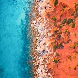 an aerial view of the sandstone cliffs of Gantheaume Point, Broome fringed by the Indian Ocean