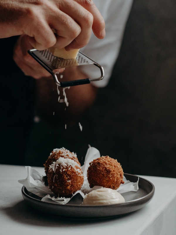 sprinkling cheese on food at No. 35 Kitchen and Bar, Cabarita