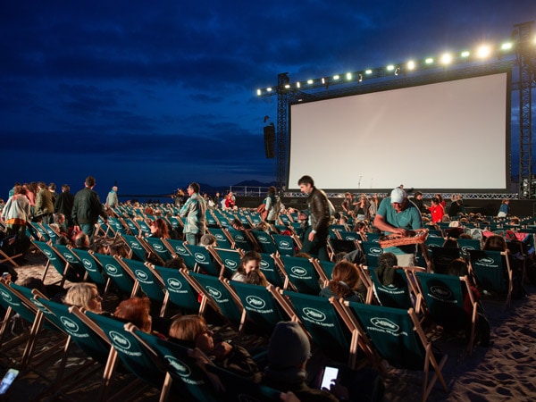 people sitting at an outdoor cinema