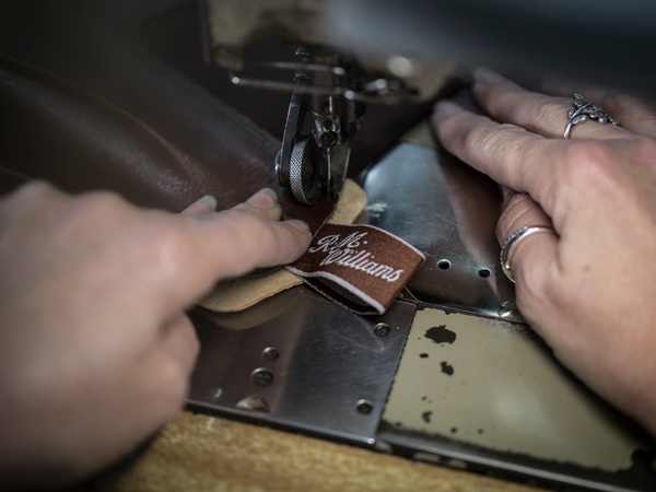 stitching a tug onto a boot at R.M. Williams Factory in Adelaide