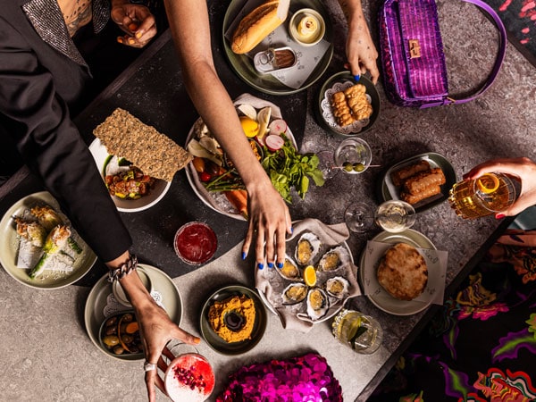a table-top view of food at Rooftop at QT Melbourne, Vic