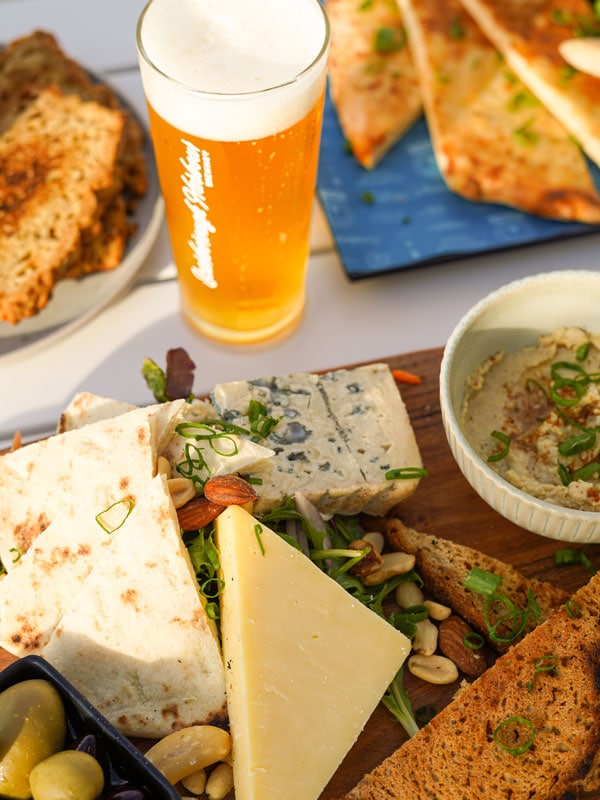 girl dinner with cheeseboard and beer at Scarborough Harbour Brewing Co