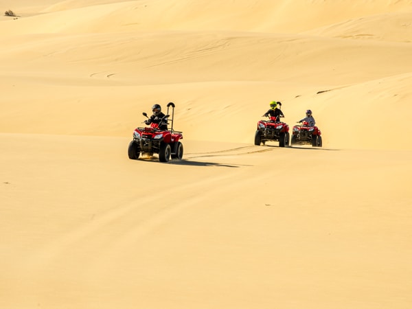 friends enjoying a Quad Bike tour on Stockton Sand Dunes