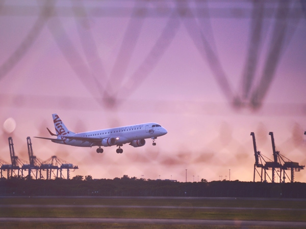 the Virgin Australia plane about to land at sunset