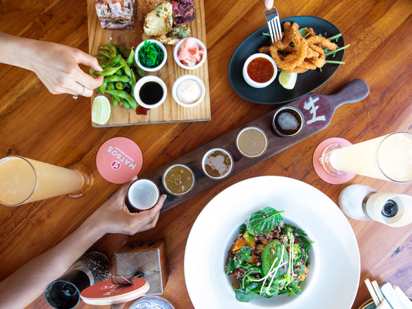 a table-top view of food and drinks at Matso’s Brewery, Broome