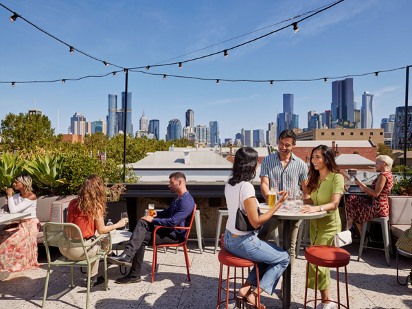 people enjoying drinks at the rooftop terrace of Johnny’s Green Room