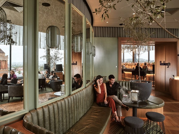 a couple sitting beside each other on a couch at Romberg's, Crystalbrook Kingsley, Newcastle