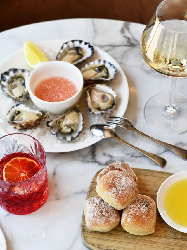 a plate of Sydney rock oysters alongside white wine and Negroni at Pescara, Pokolbin