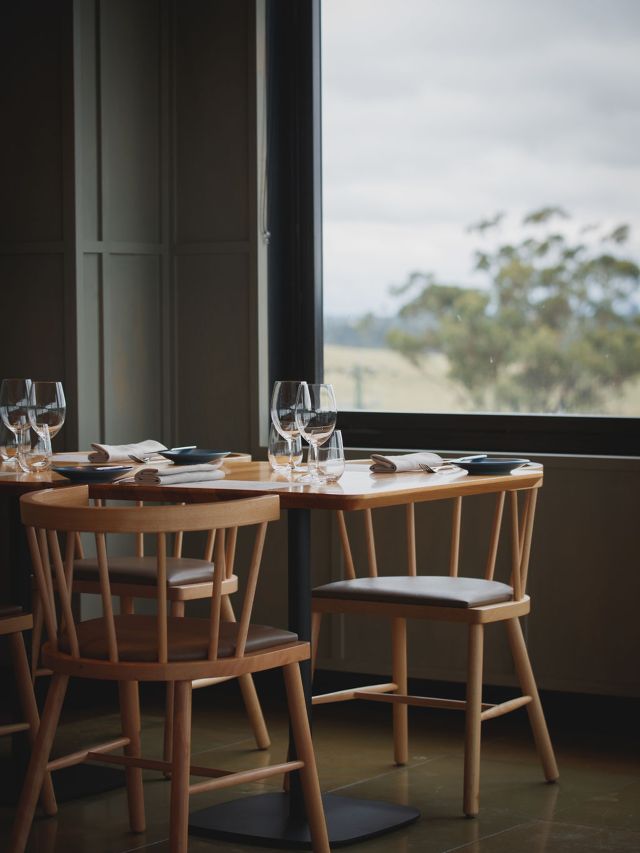 a dining table by a window at Esca, Hunter Valley