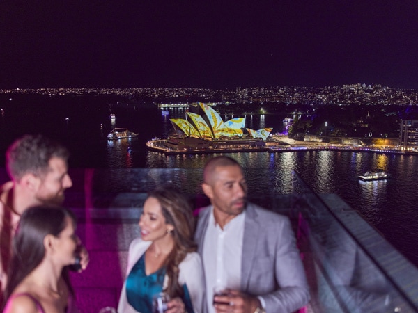Friends gather at the Pylon Lookout during Vivid