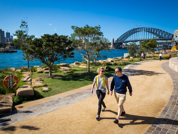 a couple walking along Barangaroo Reserve